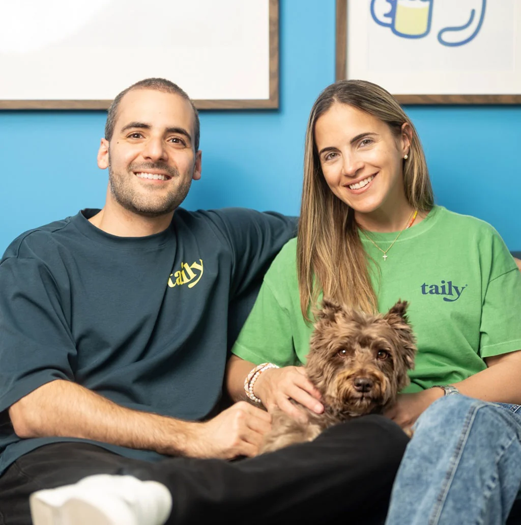 The two pharmaceutical scientists behind Taily, sitting with their dog