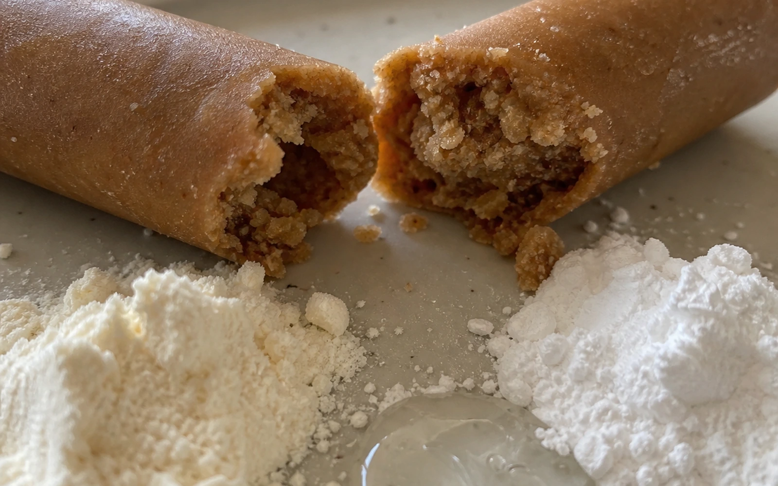 A broken dog chew beside flour, starch, and syrup